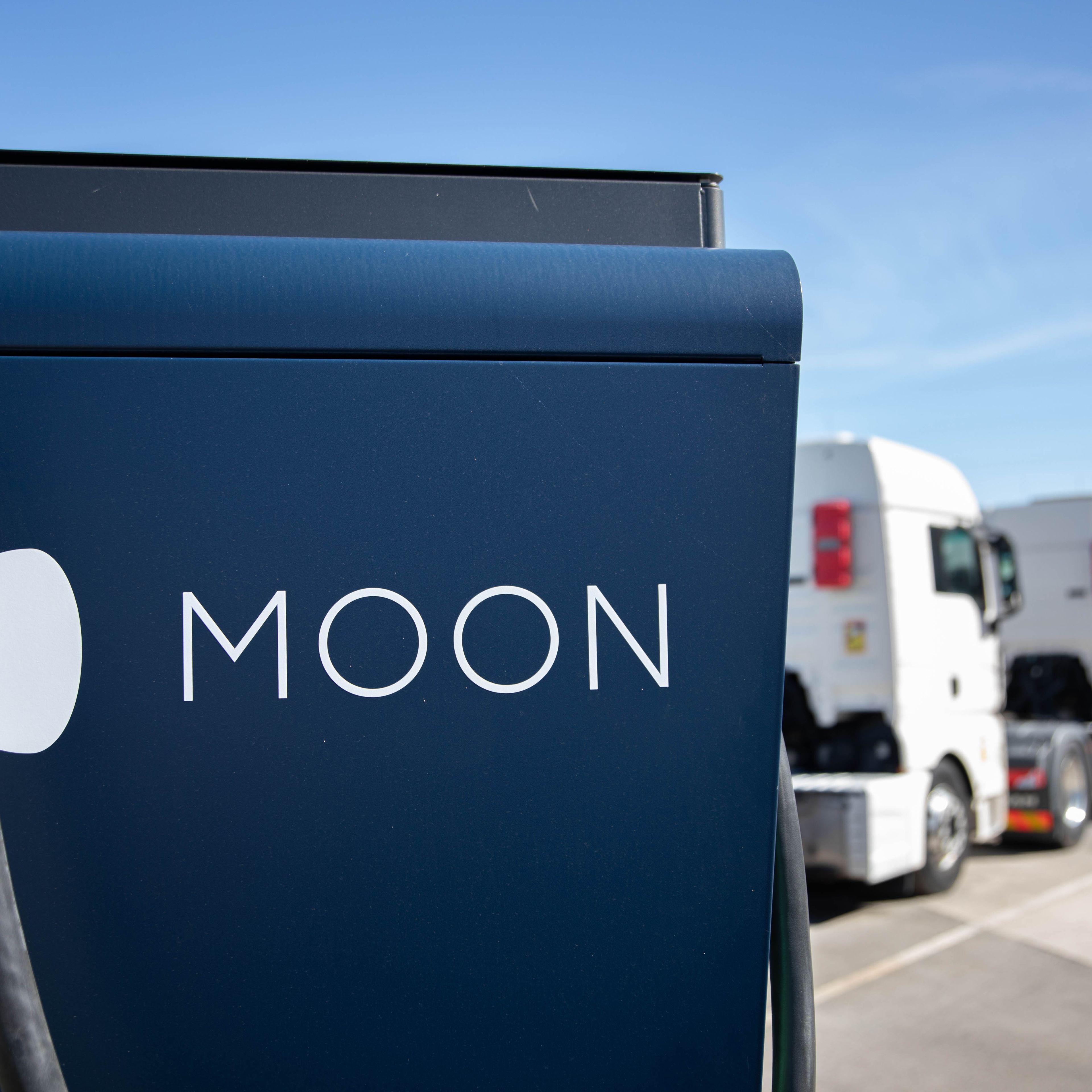 two trucks are parked behind a HYC 200-400 fast charging station