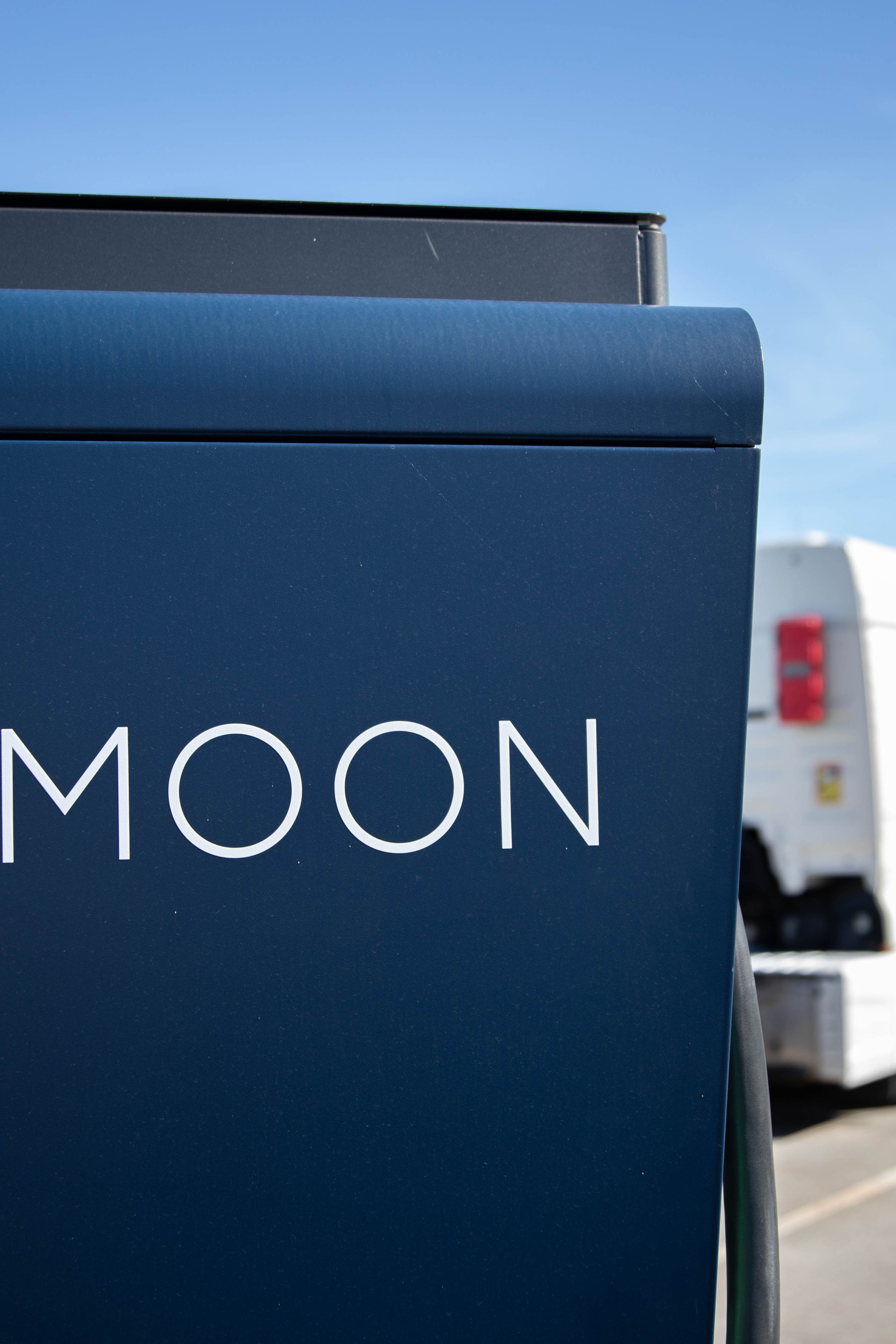 two trucks are parked behind a HYC 200-400 fast charging station