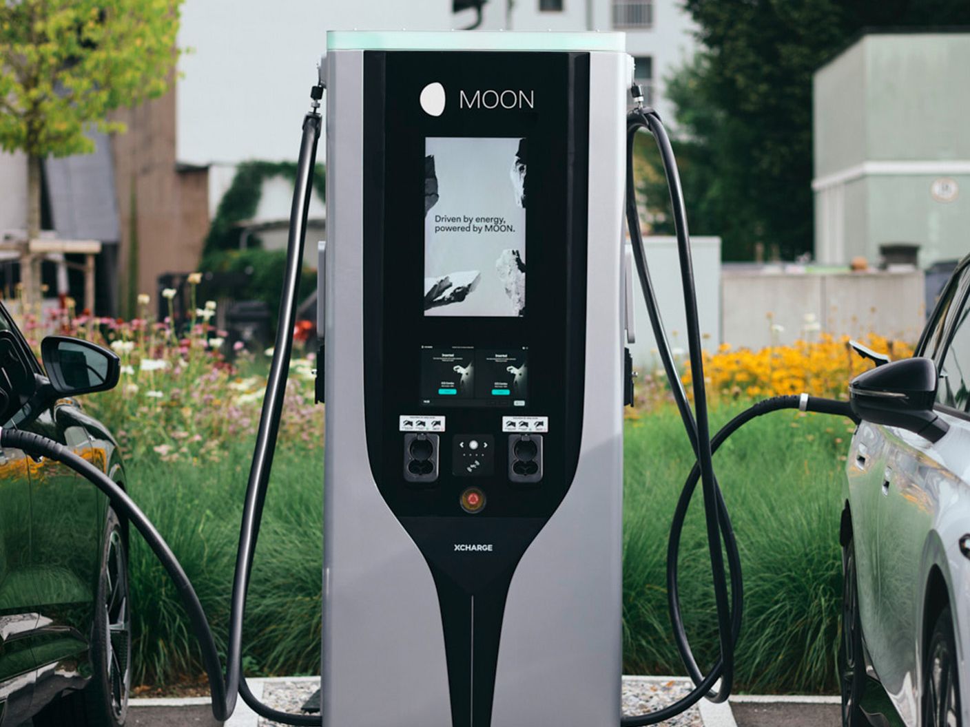 Fast charging station plugged into two electric cars