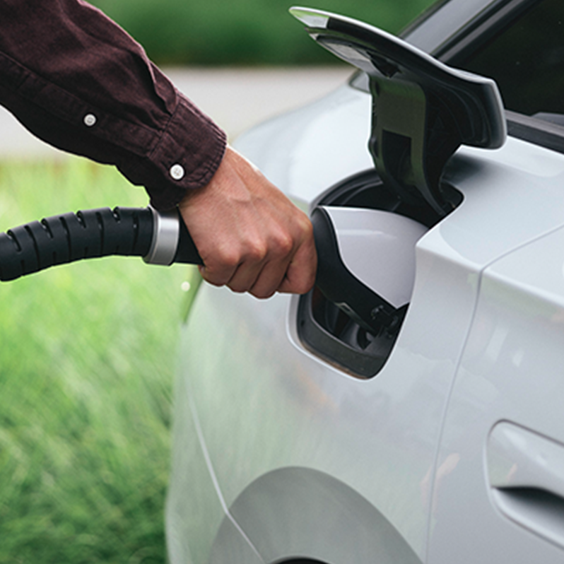 Person holding tap valve into an electric car
