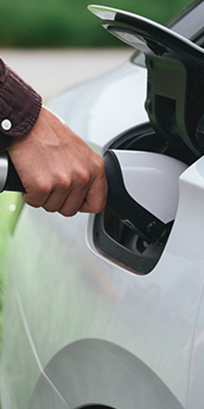Person holding tap valve into an electric car