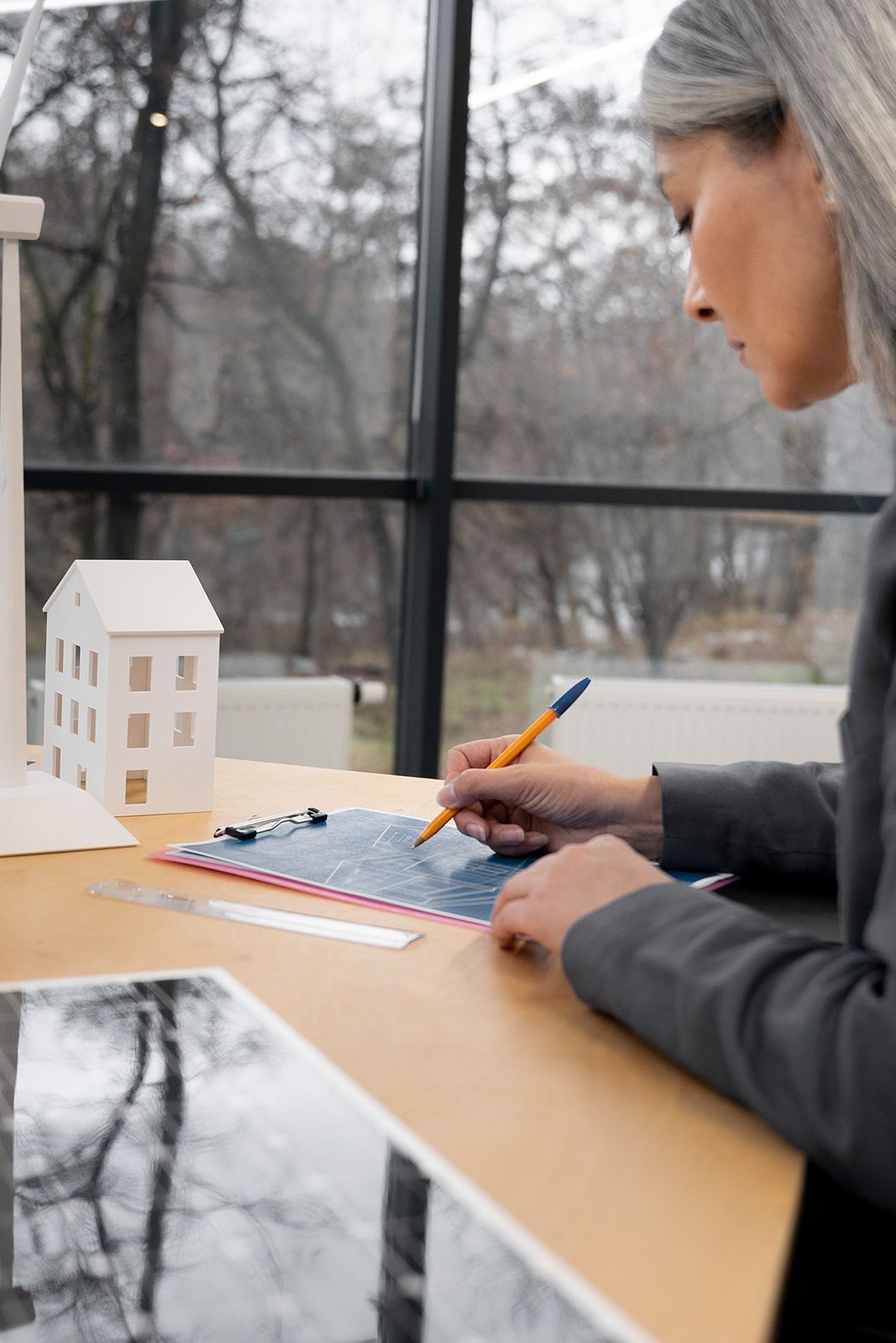 Woman stands at a table and writes something down